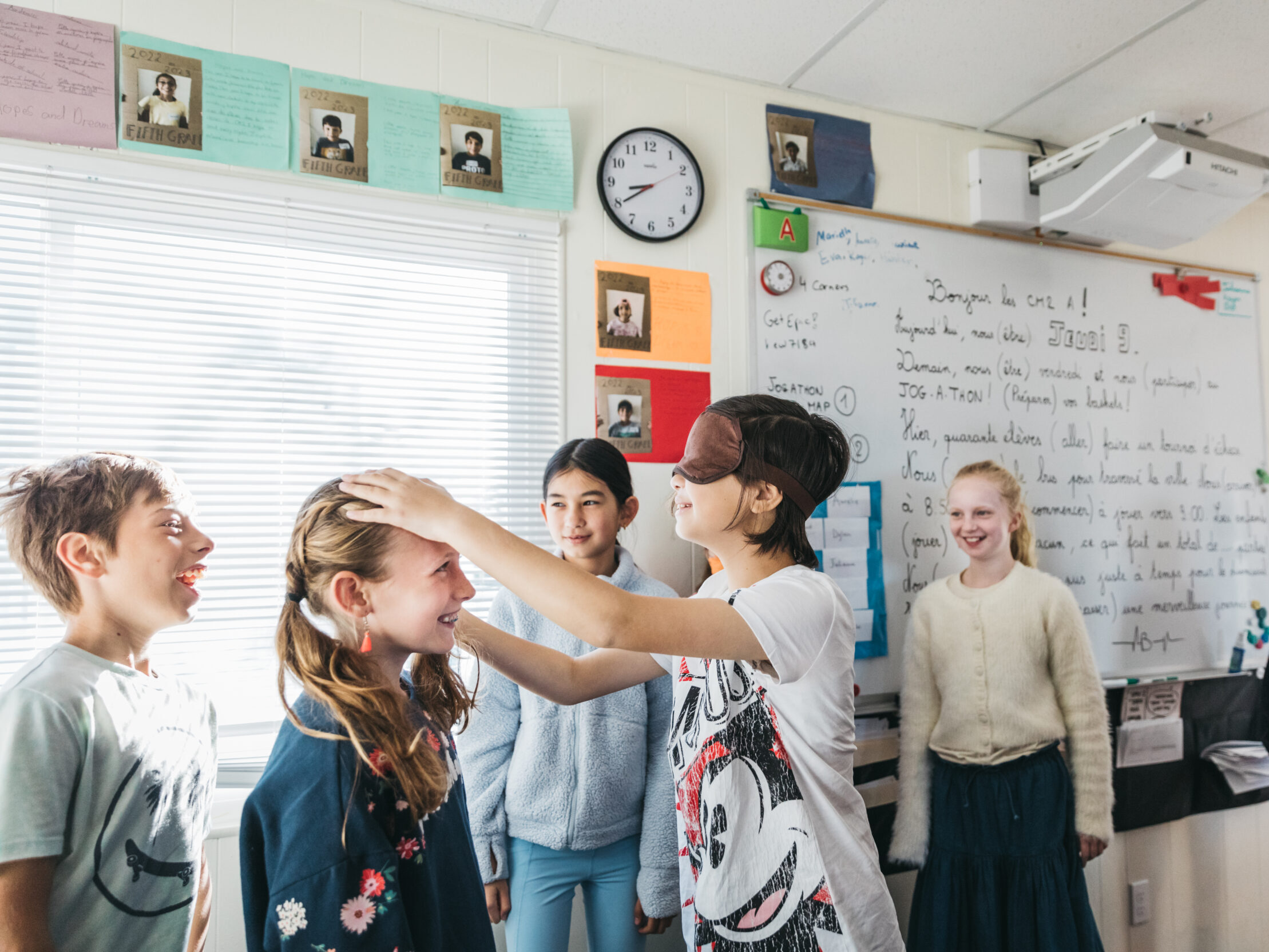 children in classroom one with blindfold