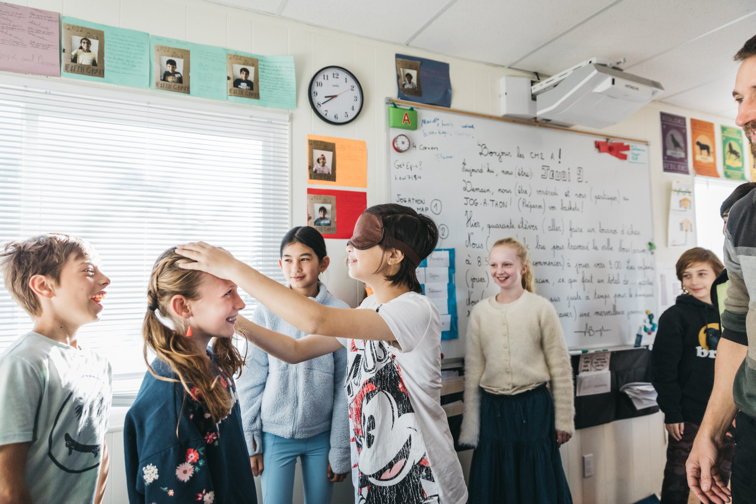 children in classroom one with blindfold