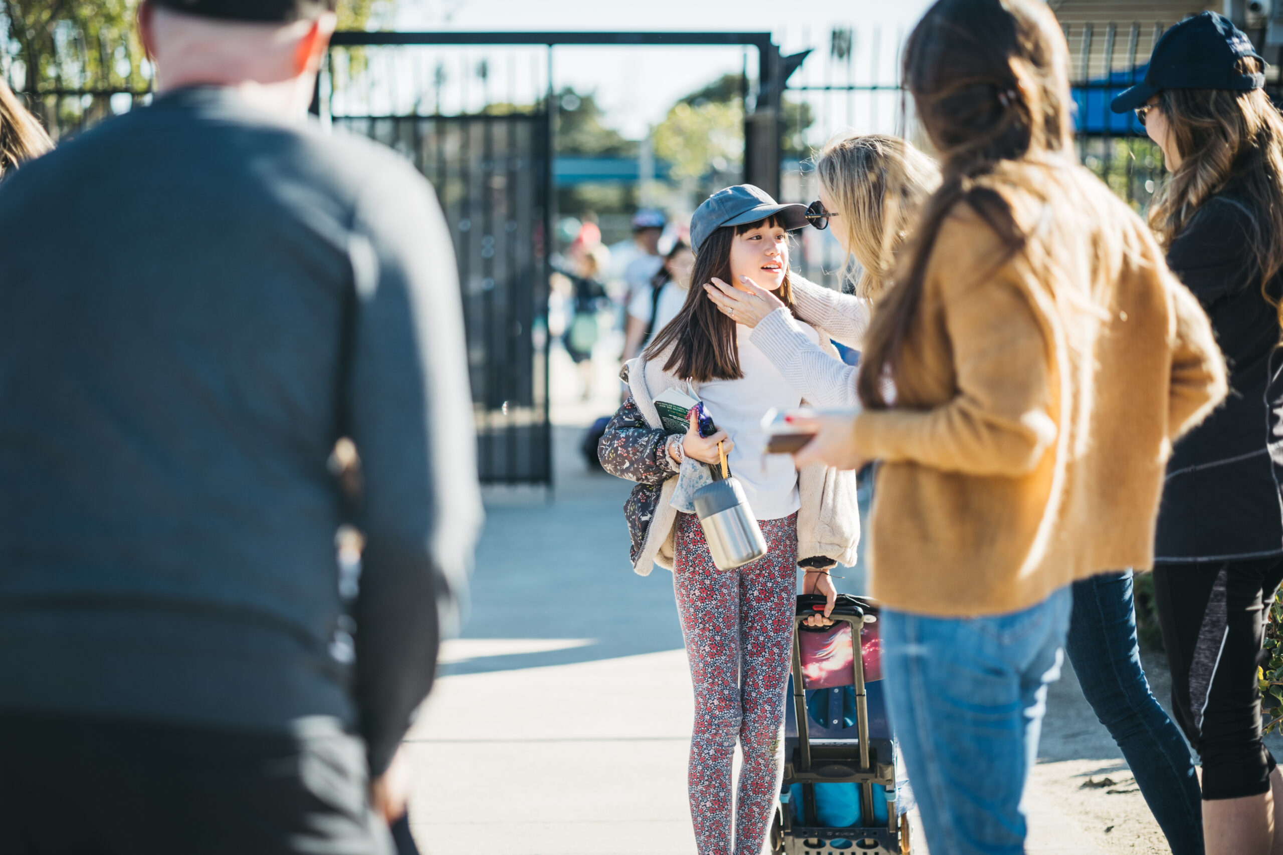 family outside child with suitcase